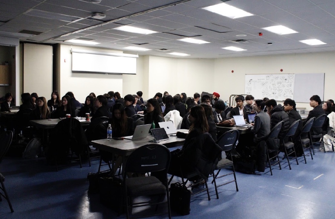 Students collaborating around a table during INSPIRE