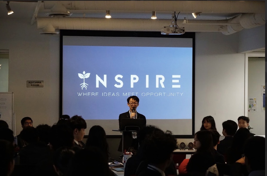 A student speaker presenting at the INSPIRE Case Competition
