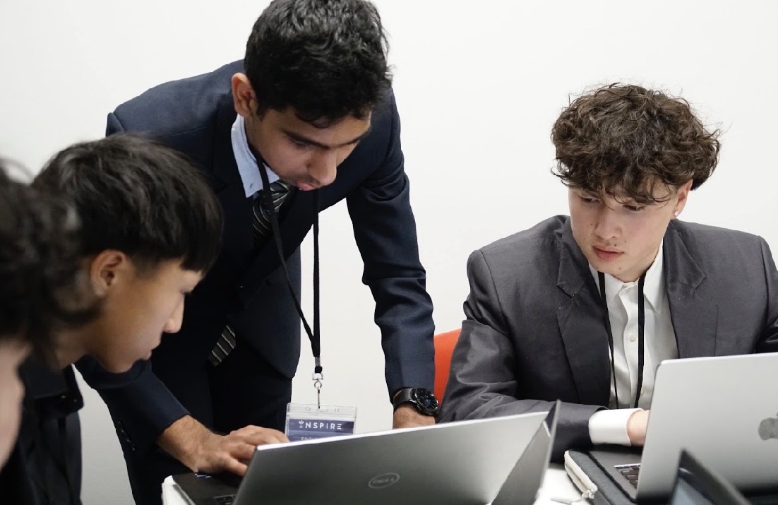 A speaker addressing the INSPIRE Case Competition room