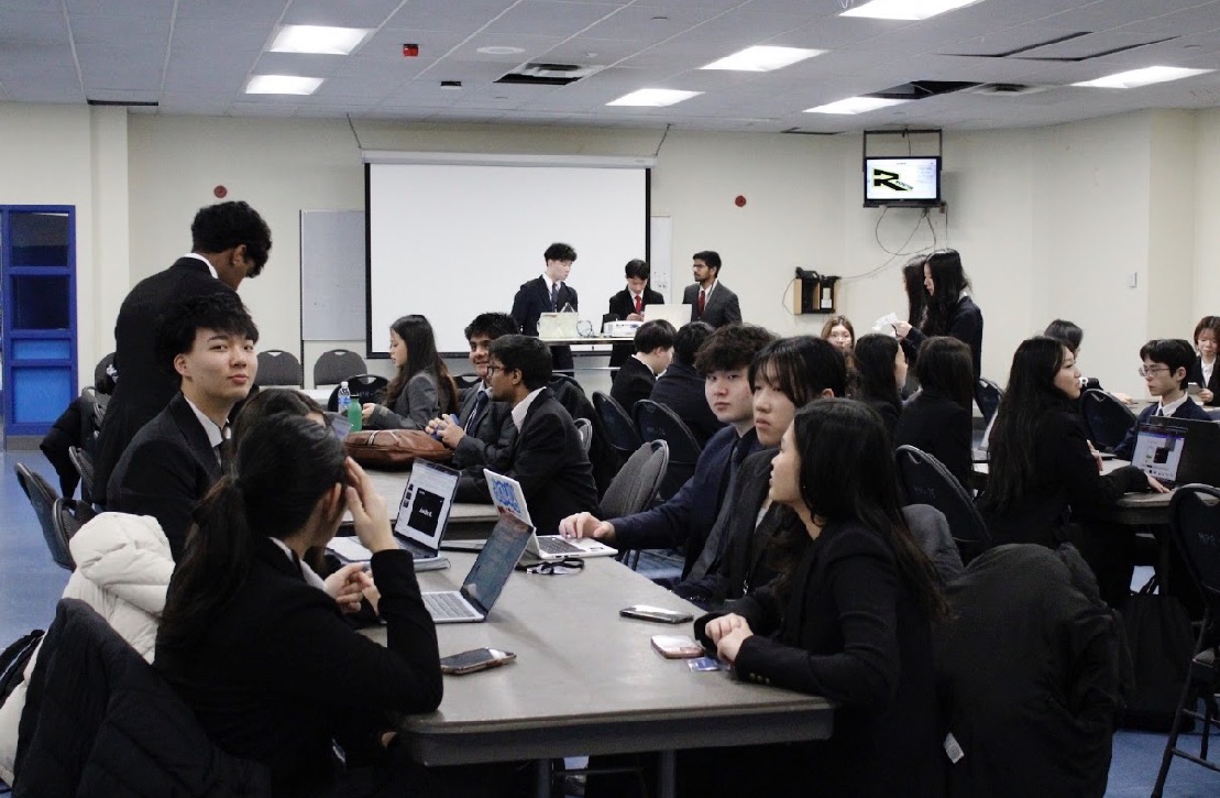 Student teams working around tables at Inspire Case Competition