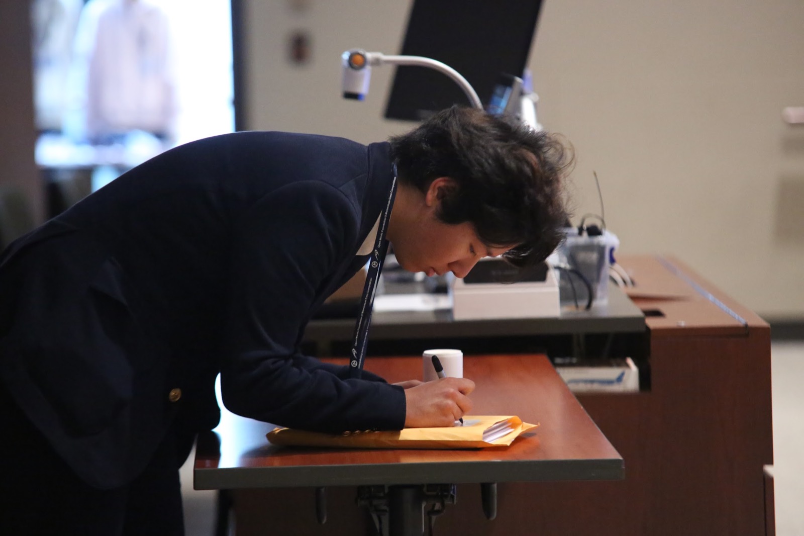 A Momentum participant writing notes at a desk