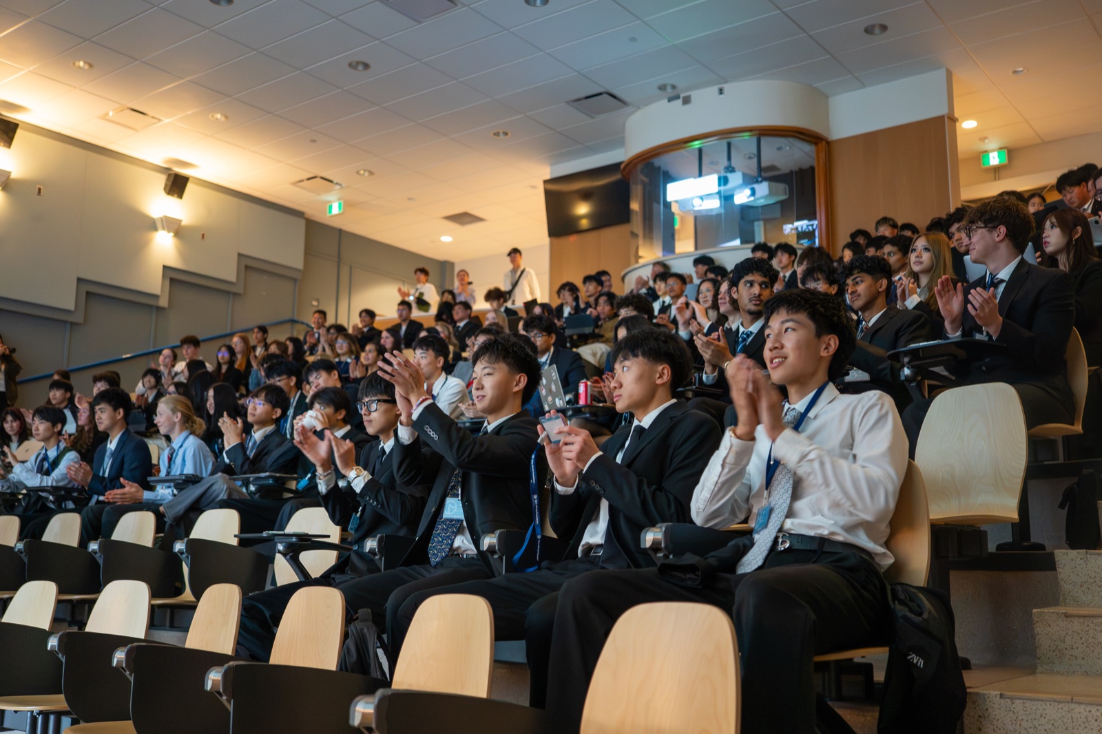 Students applauding in a lecture hall at Velocity Case Competition